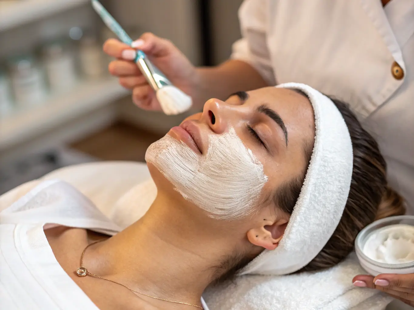 A close-up image of a client enjoying a relaxing facial treatment, surrounded by soothing ambiance and professional care.